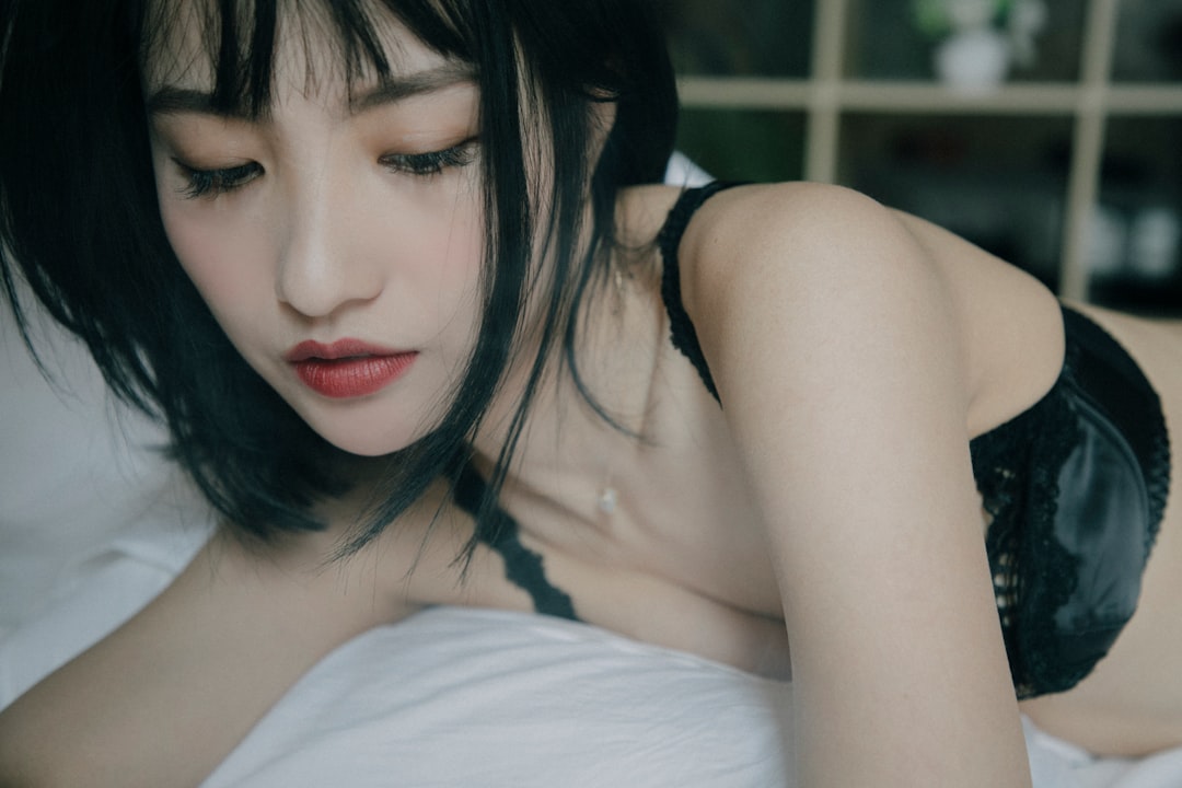 a-woman-laying-in-bed-with-her-eyes-closed-z4ygee7nk-o